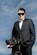 Pet Photography, Black Great Dane with Owner in a 'Blues Brothers' Style photo. Owner in suit with tie and sunglasses blue sky background