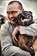 Pet Photography, Male owner cuddling pet Staffordshire Bull Terrier