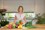 Business Branding - Woman standing in Kitchen with fresh fruit and vegetables - ready to cook healthily